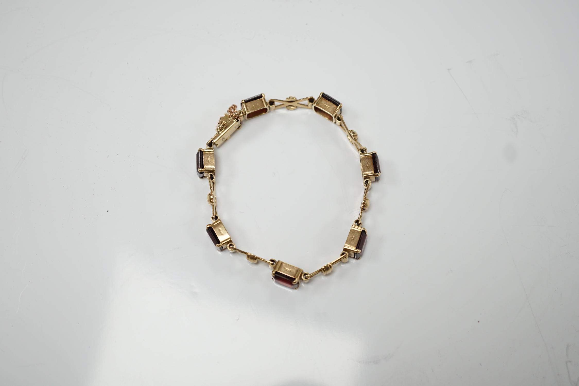 A 1960's 9ct gold and seven stone garnet set bracelet, by Cropp & Farr, 18cm, gross weight 17.9 grams.